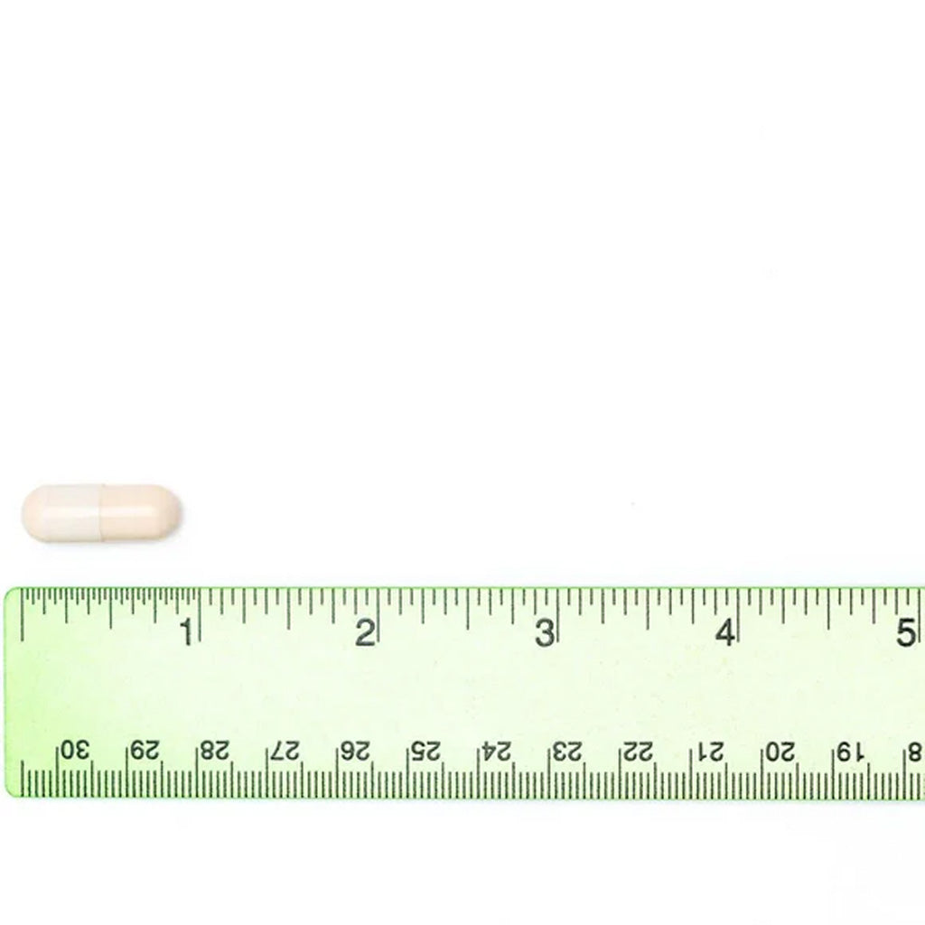 White pill next to a ruler on a white background Vetriscience Cardio