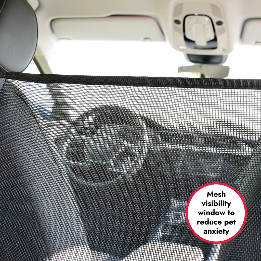 Car interior with a mesh visibility window for pets, showing steering wheel and dashboard.