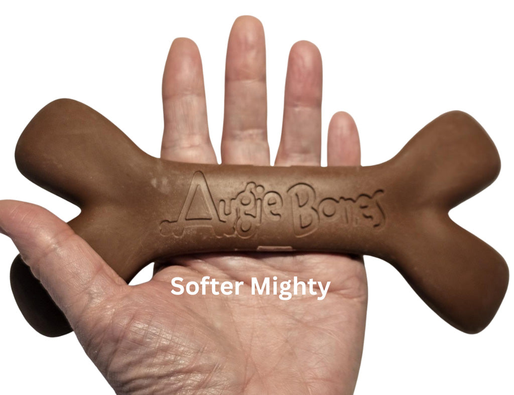Brown dog chew toy shaped like a bone held in a hand, with 'Augie Bones' branding.