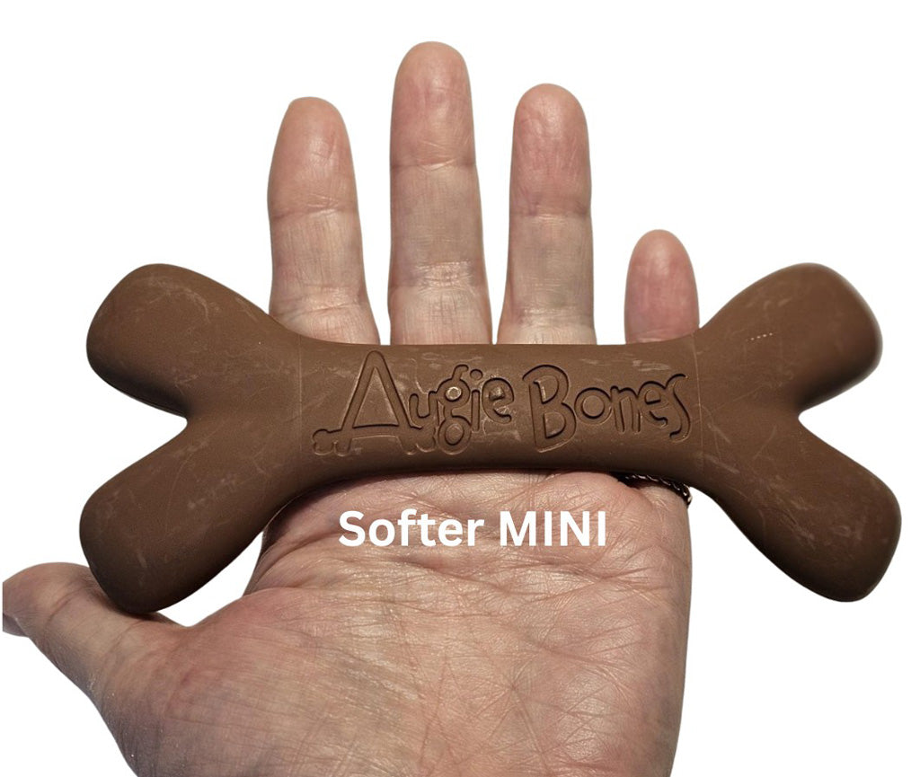 Brown dog toy shaped like a bone held in a hand, with 'Augie Bones' branding.