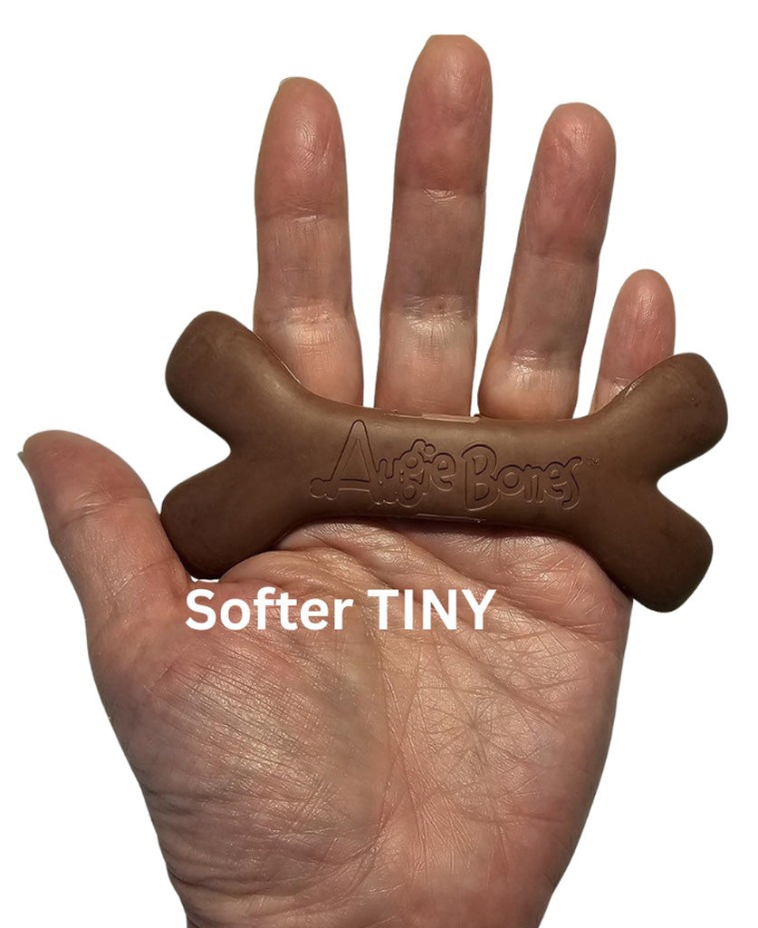 Brown dog chew toy held in a hand with 'Augie Bones' branding, labeled 'Softer TINY'.